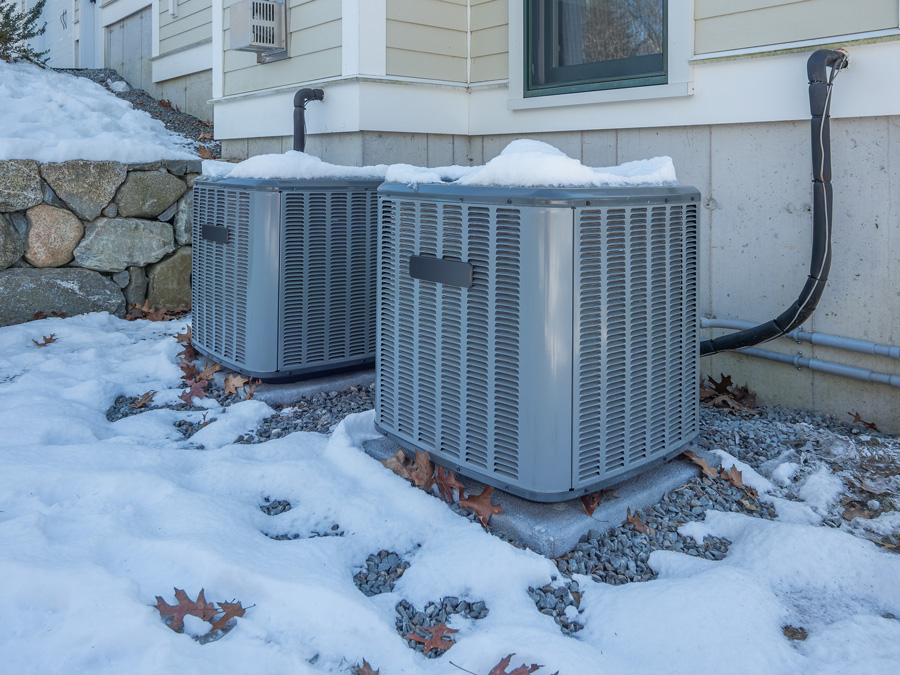 hvac systems next to eachother in the snow Clay's Climate Control
