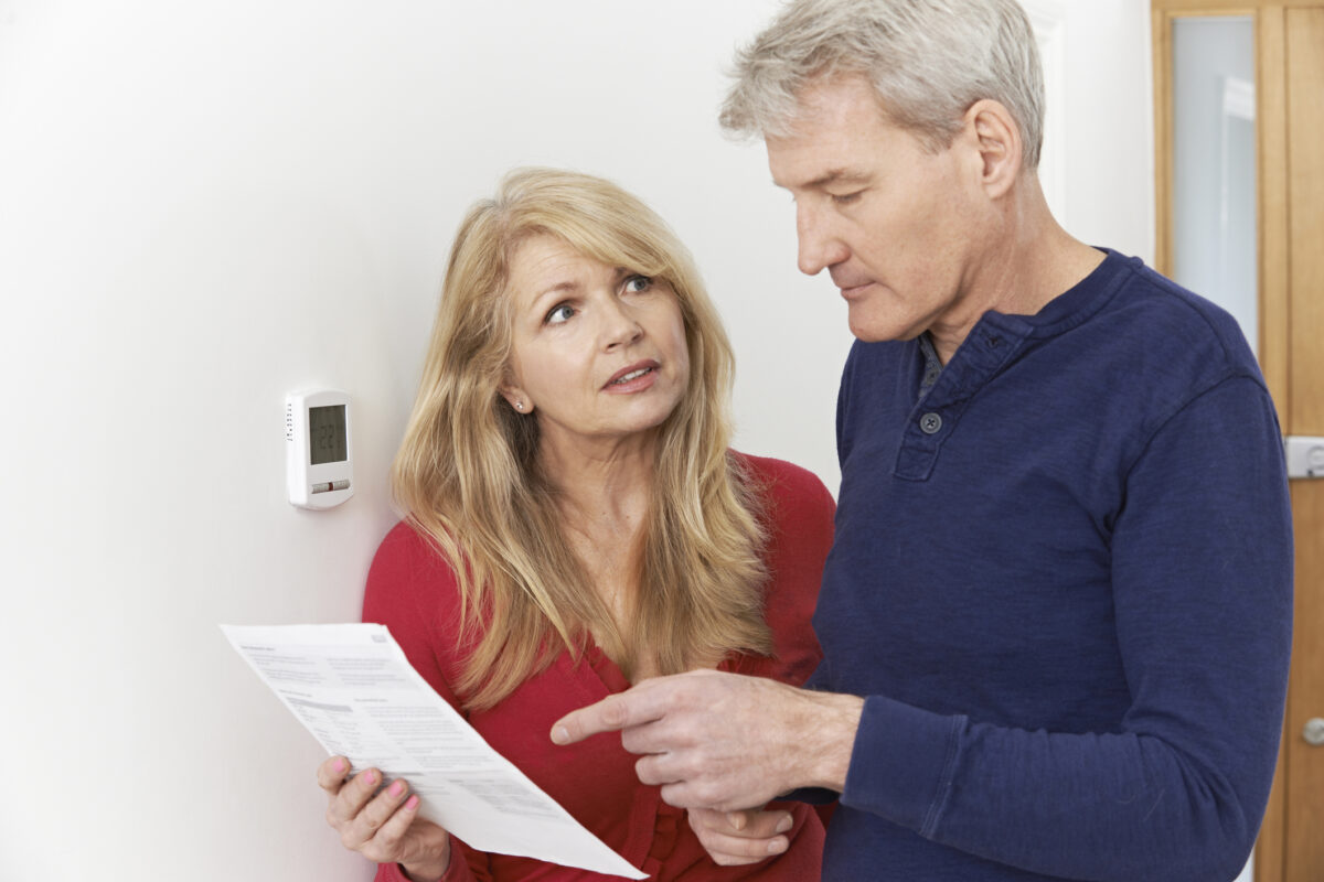 Couple looking at their monthly energy bills with concern